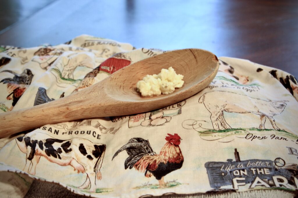 spoon full of milk kefir grains sitting on table