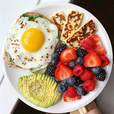 Healthy breakfast with egg avocado fruit and bread